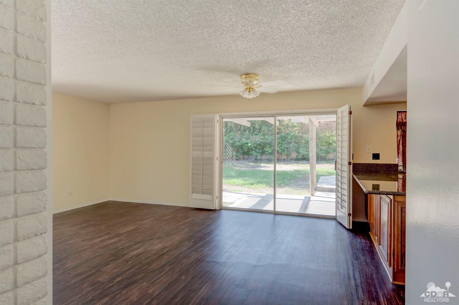 73769 Haystack Road Palm Desert, CA 92260 - Photo 15 of 34 wooden floor in an empty room with a window