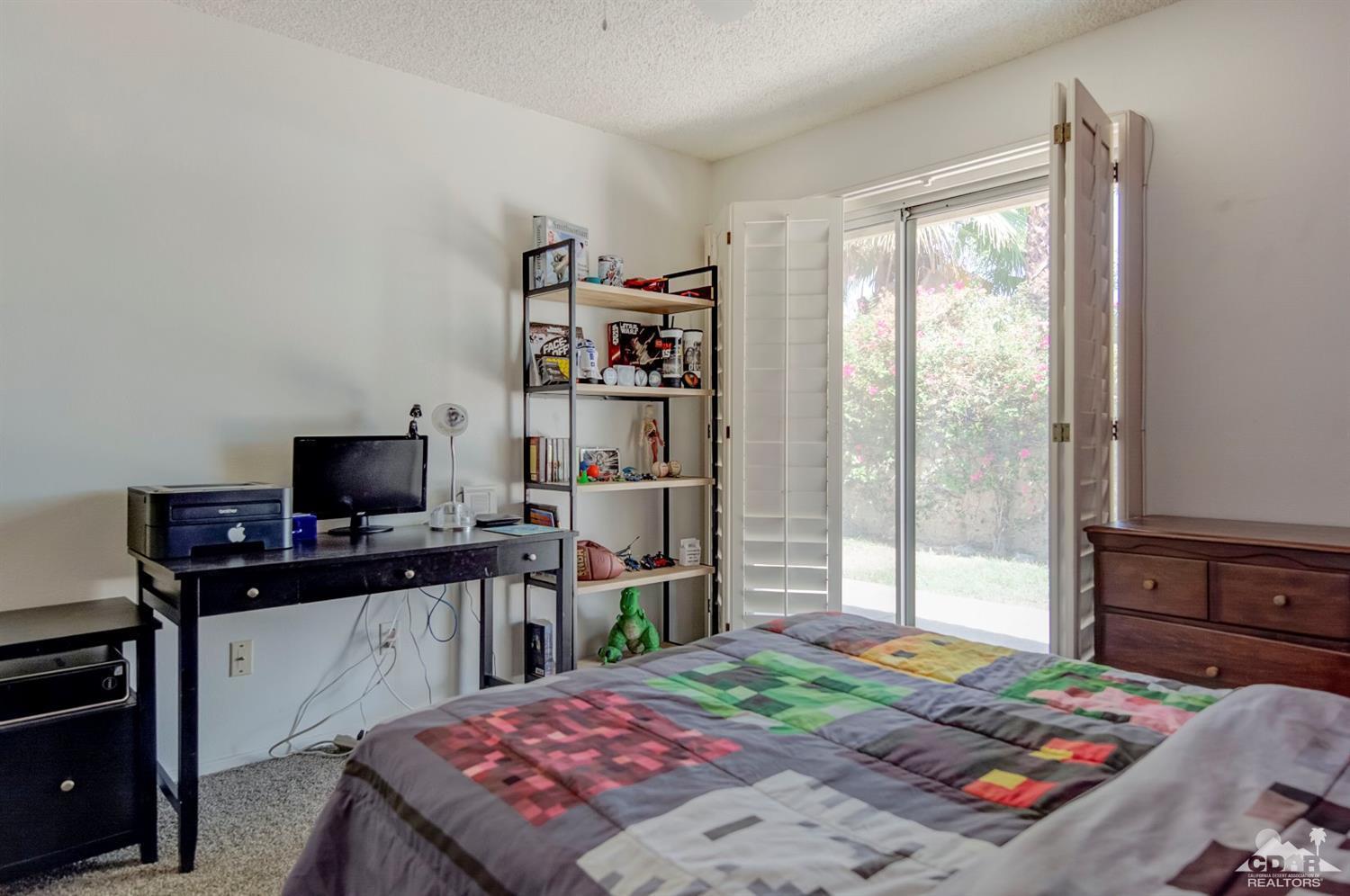 73769 Haystack Road Palm Desert, CA 92260 - Photo 23 of 34 a bedroom with a bed and a flat screen tv