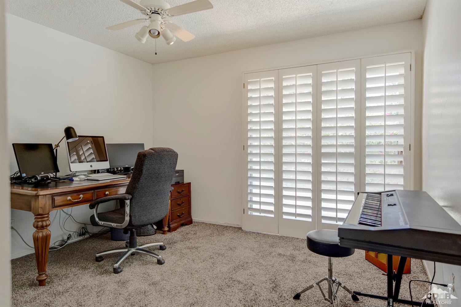 73769 Haystack Road Palm Desert, CA 92260 - Photo 25 of 34 a view of a workspace with furniture and a window