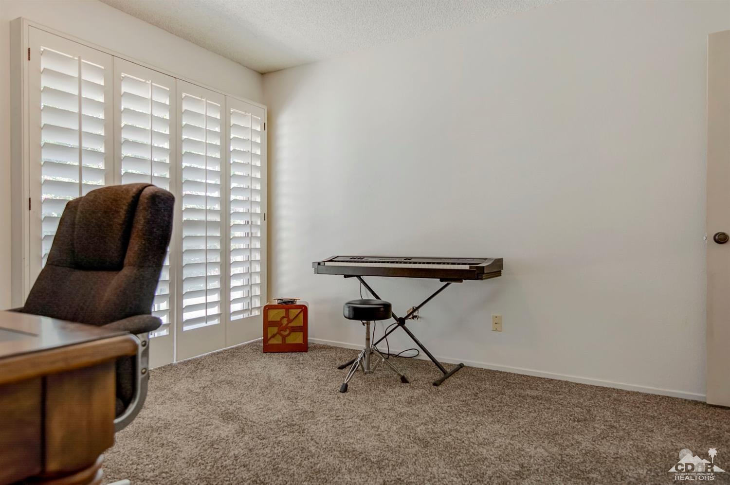 73769 Haystack Road Palm Desert, CA 92260 - Photo 26 of 34 a living room with furniture and a window
