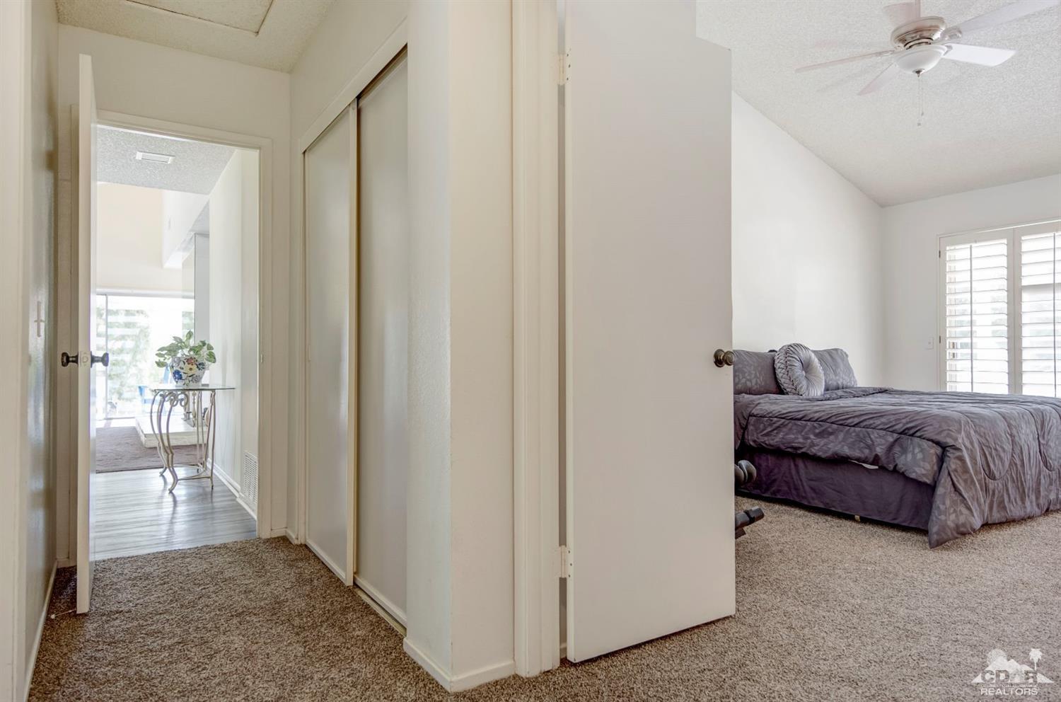 73769 Haystack Road Palm Desert, CA 92260 - Photo 28 of 34 a bedroom with a bed and a mirror