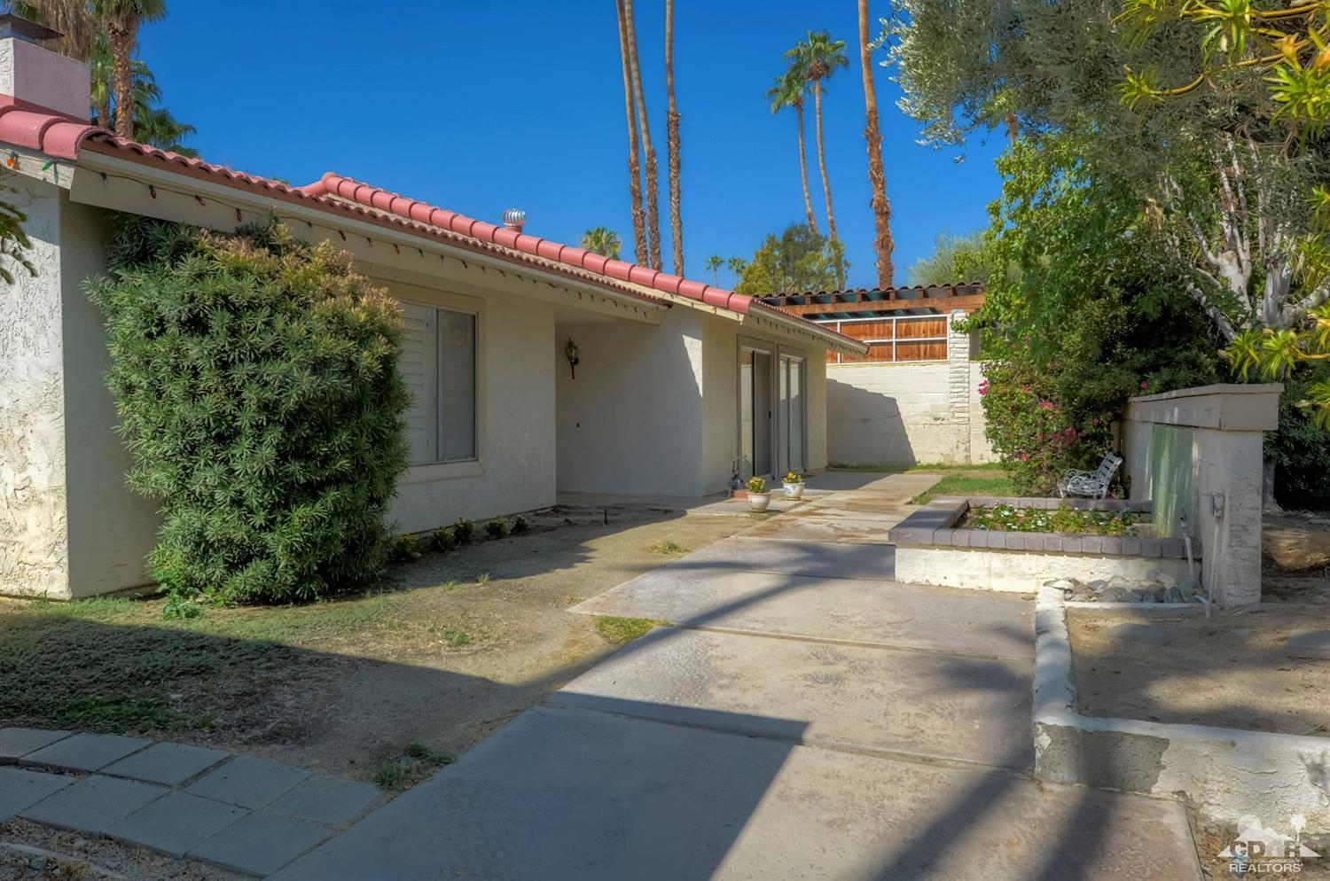73769 Haystack Road Palm Desert, CA 92260 - Photo 4 of 34 a front view of a house with a yard