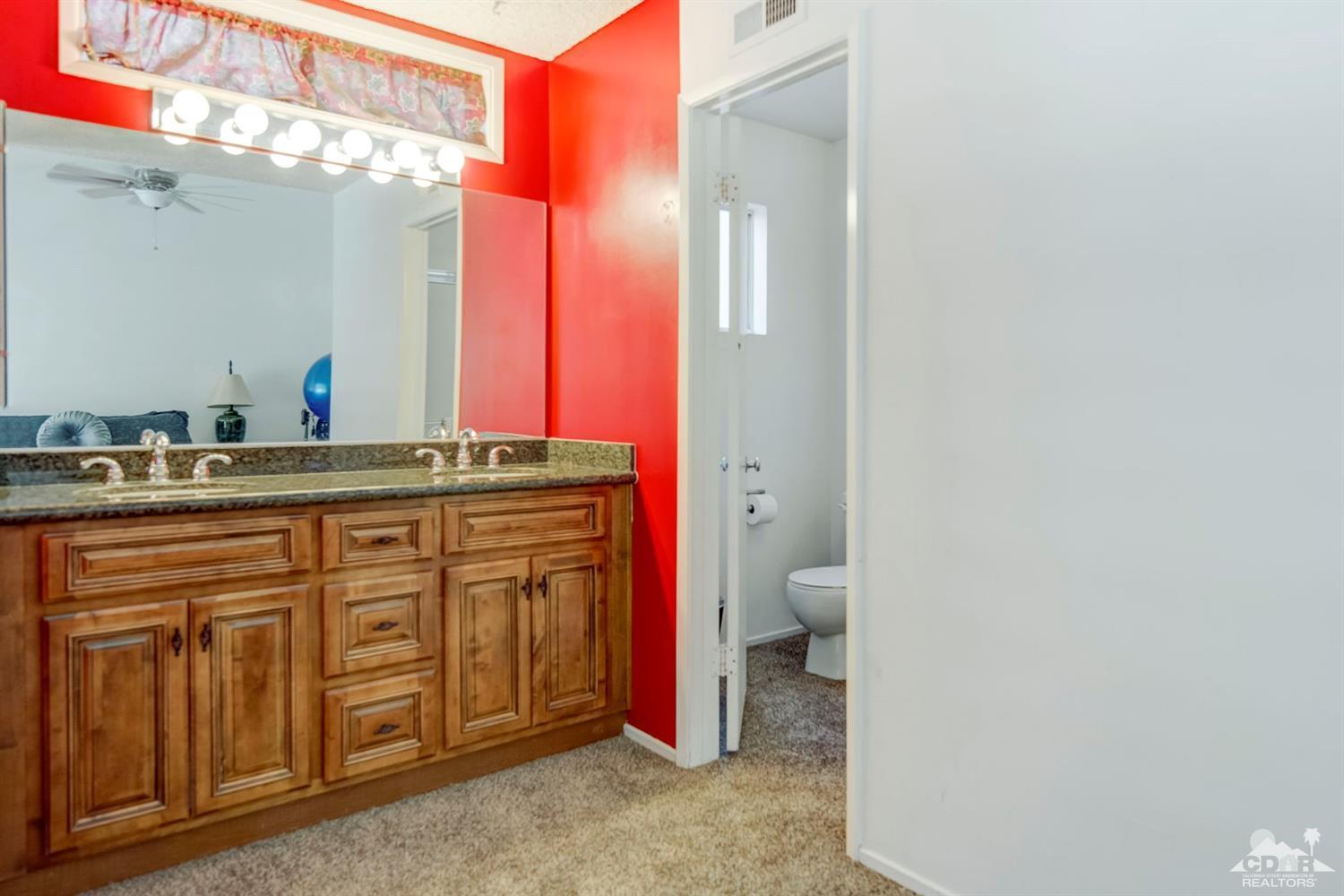 73769 Haystack Road Palm Desert, CA 92260 - Photo 34 of 34 a spacious bathroom with a granite countertop sink and a mirror