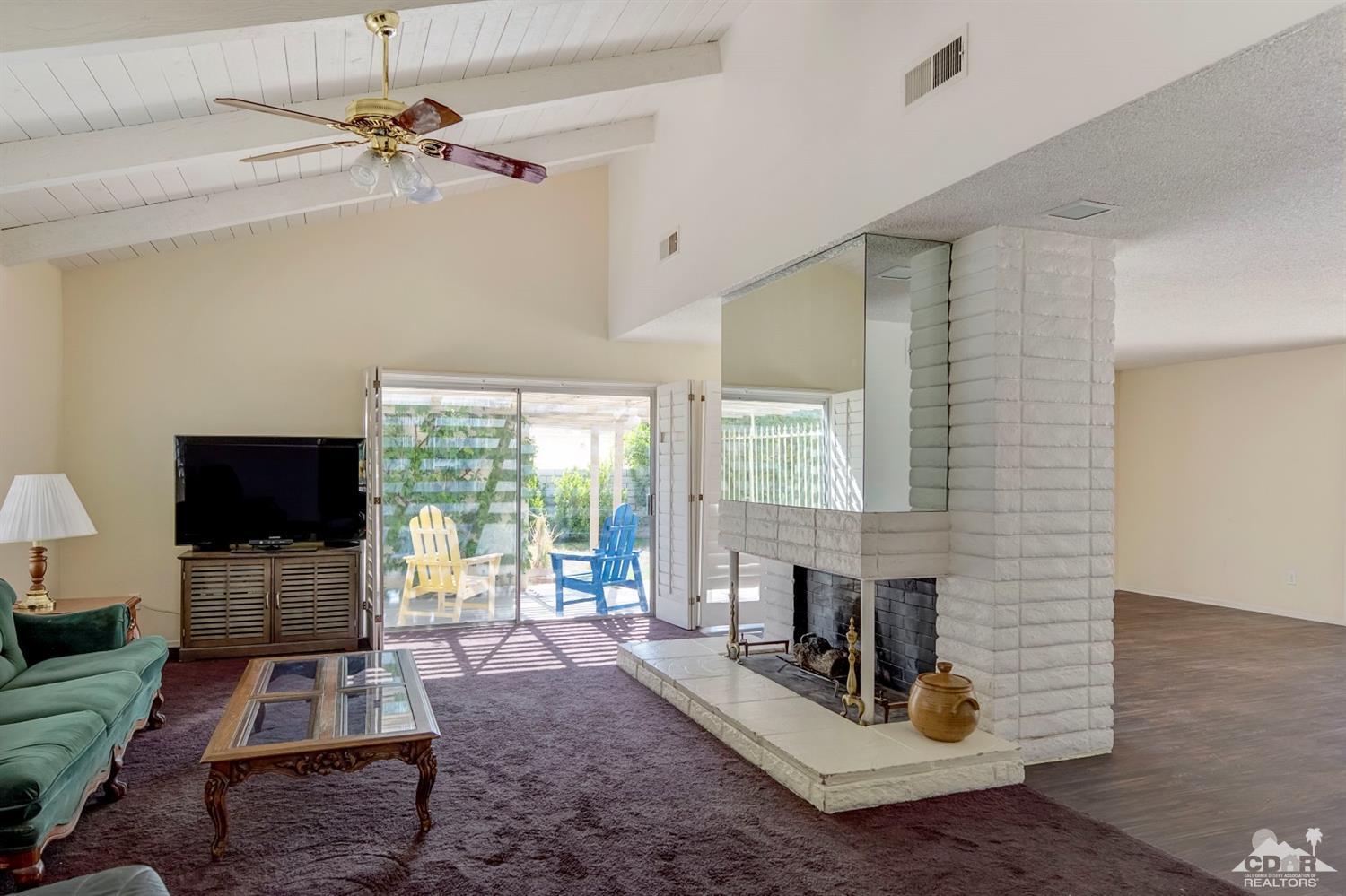 73769 Haystack Road Palm Desert, CA 92260 - Photo 8 of 34 a living room with furniture and a flat screen tv