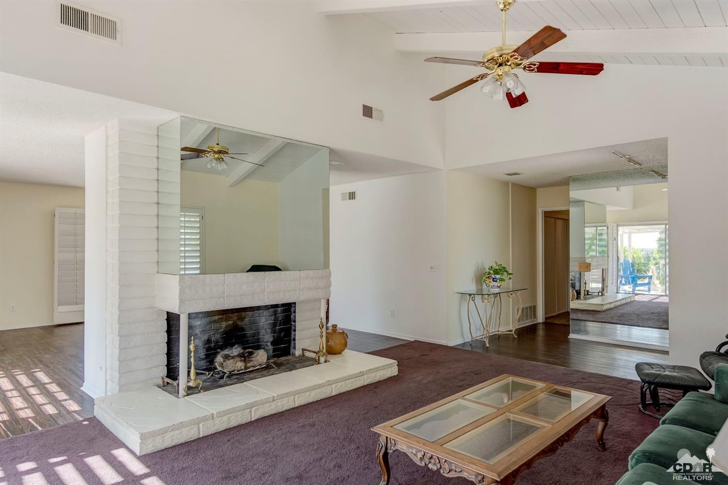 73769 Haystack Road Palm Desert, CA 92260 - Photo 10 of 34 a living room with furniture and a fireplace