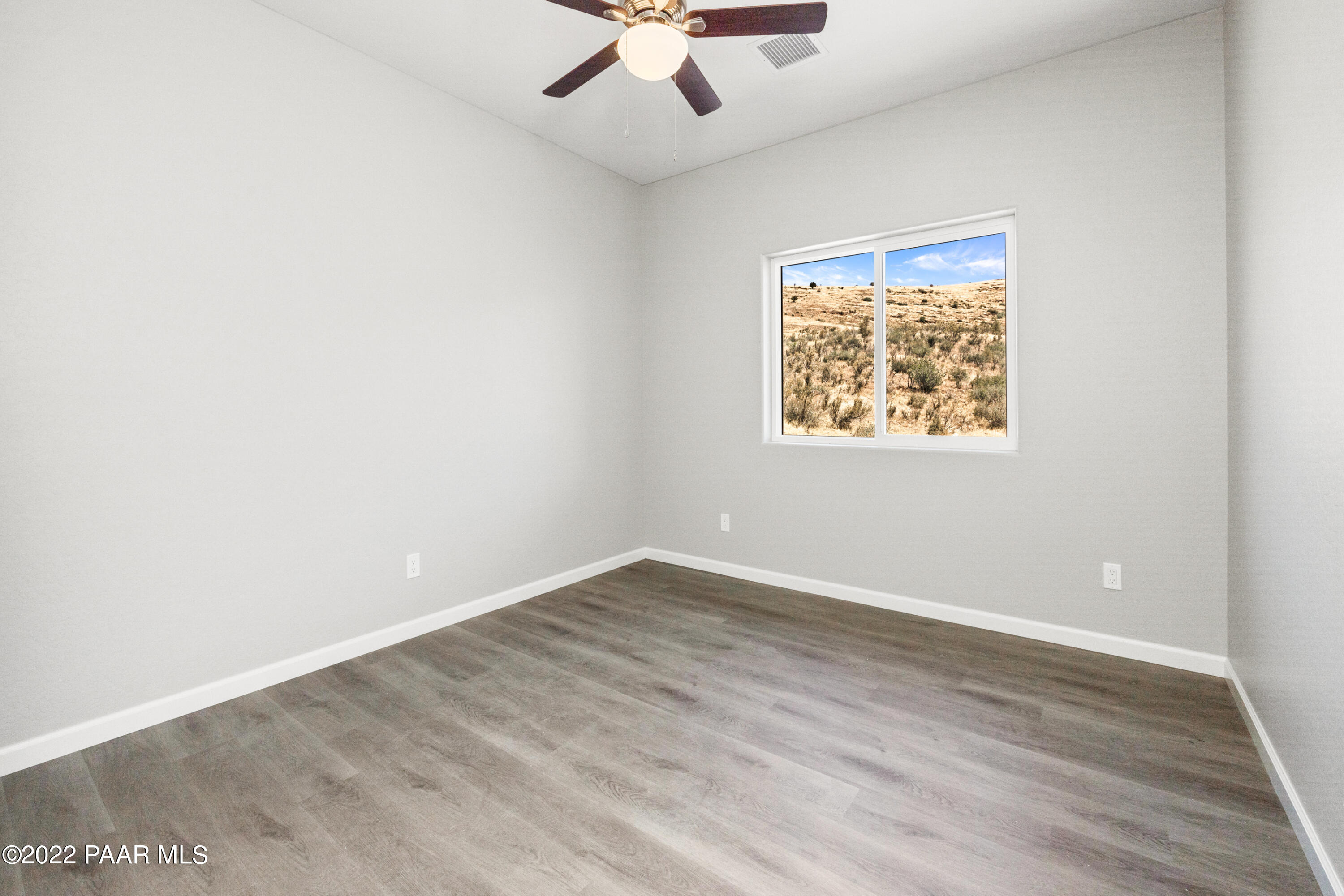 4726 East Amber Road Prescott, AZ 86301 - Photo 11 of 24 an empty room with a window and a ceiling fan
