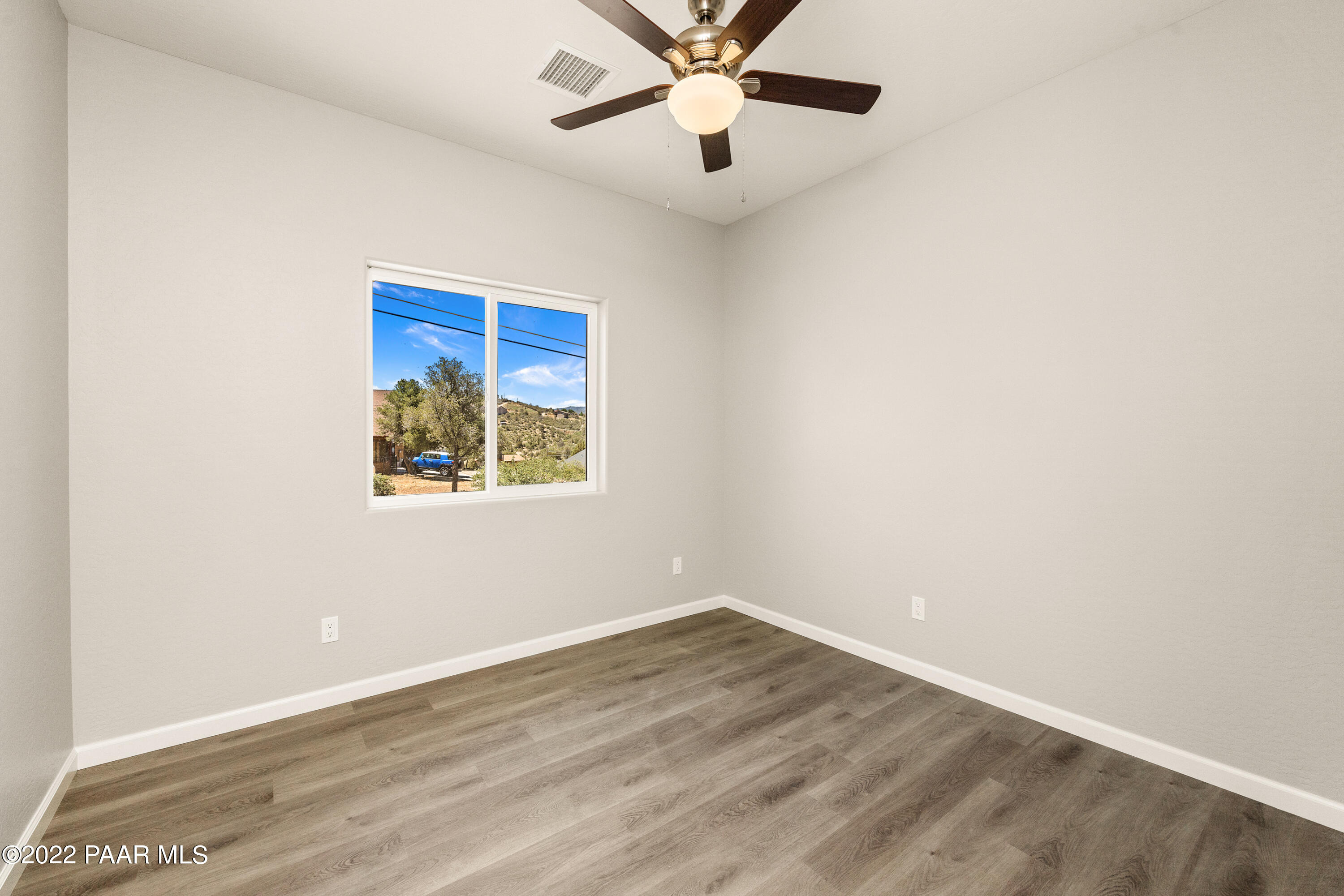 4726 East Amber Road Prescott, AZ 86301 - Photo 13 of 24 an empty room with a window and ceiling fan