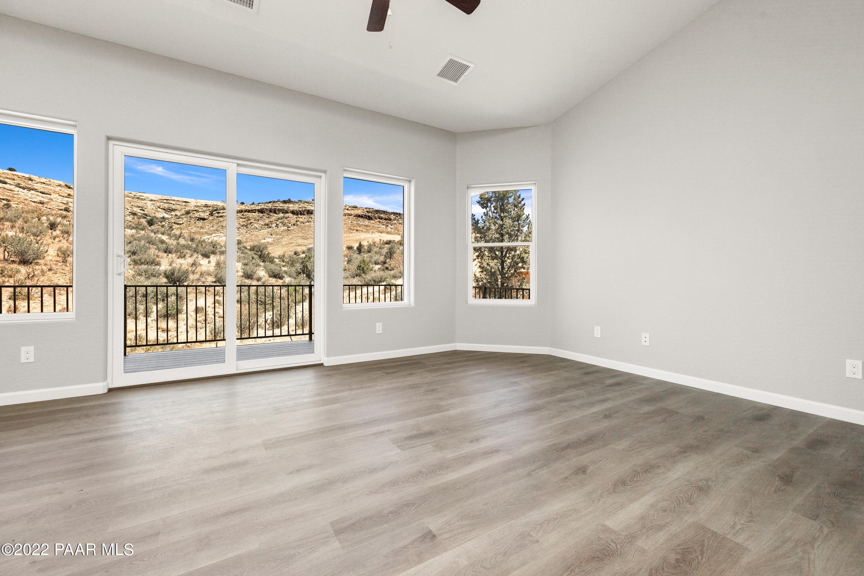 4726 East Amber Road Prescott, AZ 86301 - Photo 3 of 24 an empty room with wooden floor and windows