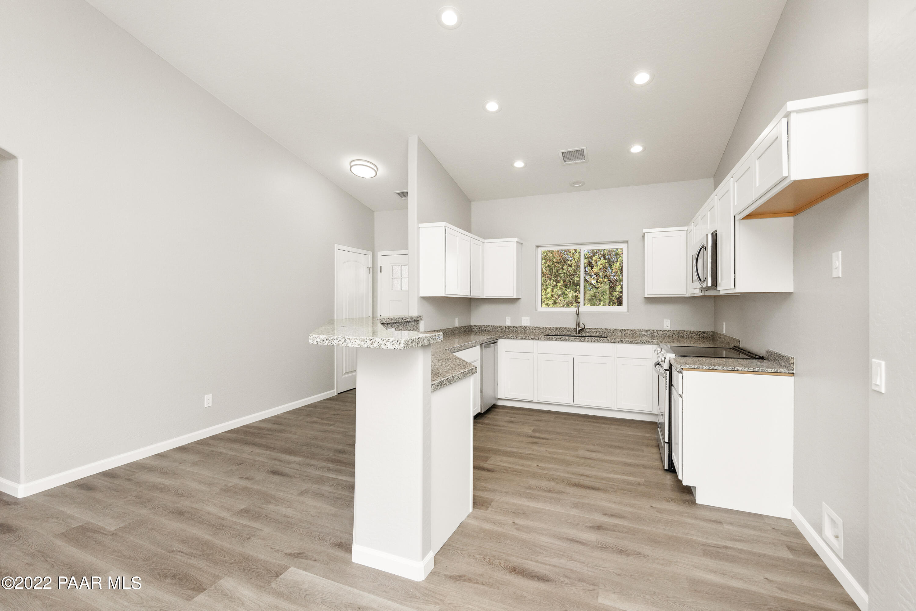 4726 East Amber Road Prescott, AZ 86301 - Photo 7 of 24 a large kitchen with a white stove top oven and white cabinets