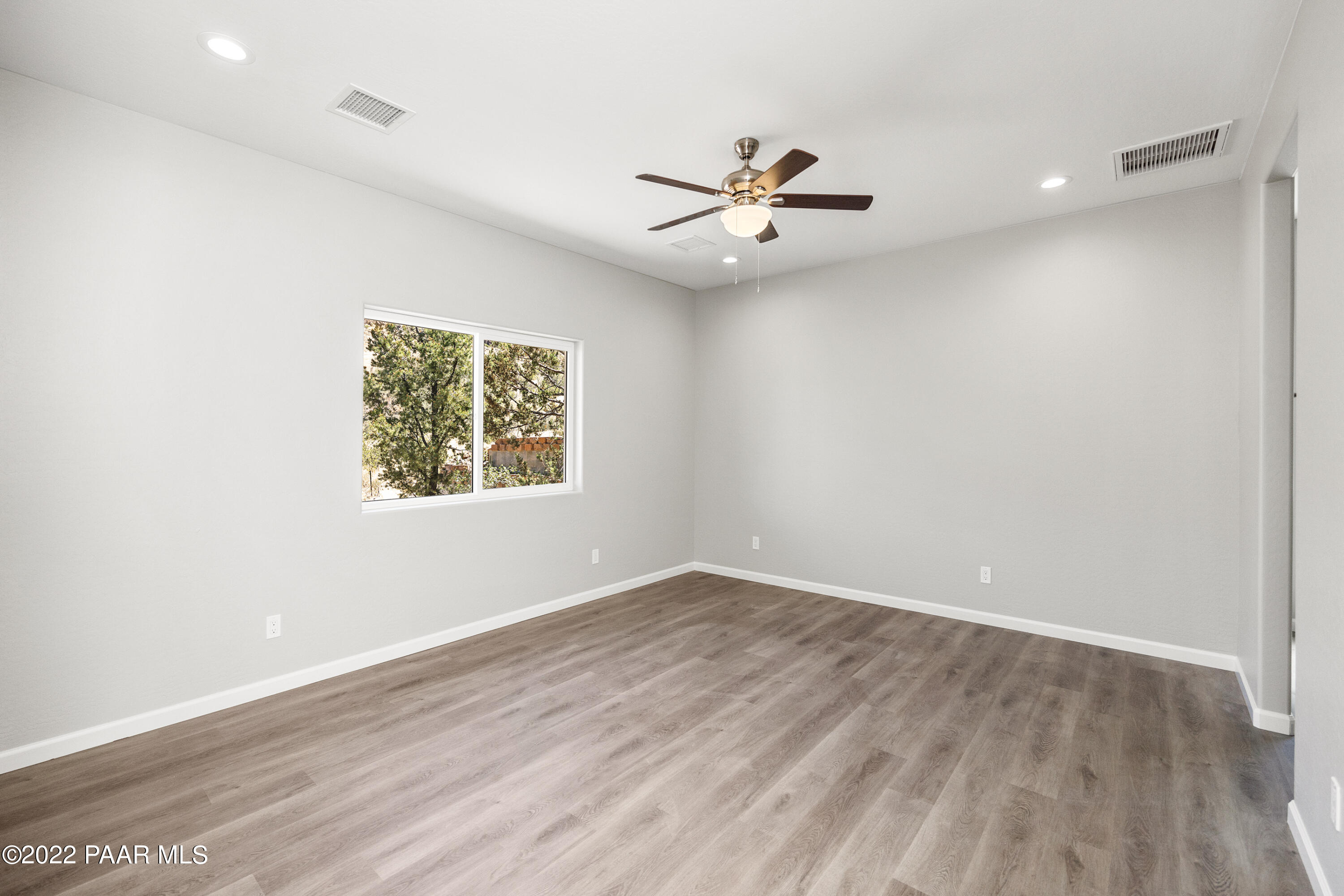 4726 East Amber Road Prescott, AZ 86301 - Photo 9 of 24 an empty room with wooden floor closet and windows