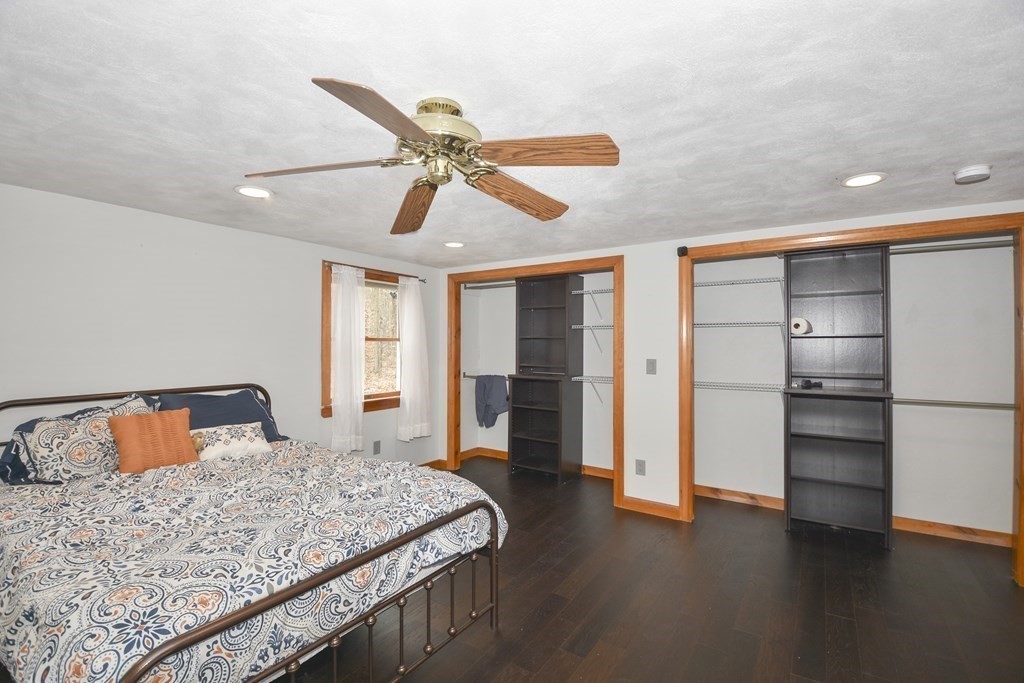 22 Carleton Road Leicester, MA 01542 - Photo 13 of 28 a bedroom with a bed and wooden floor