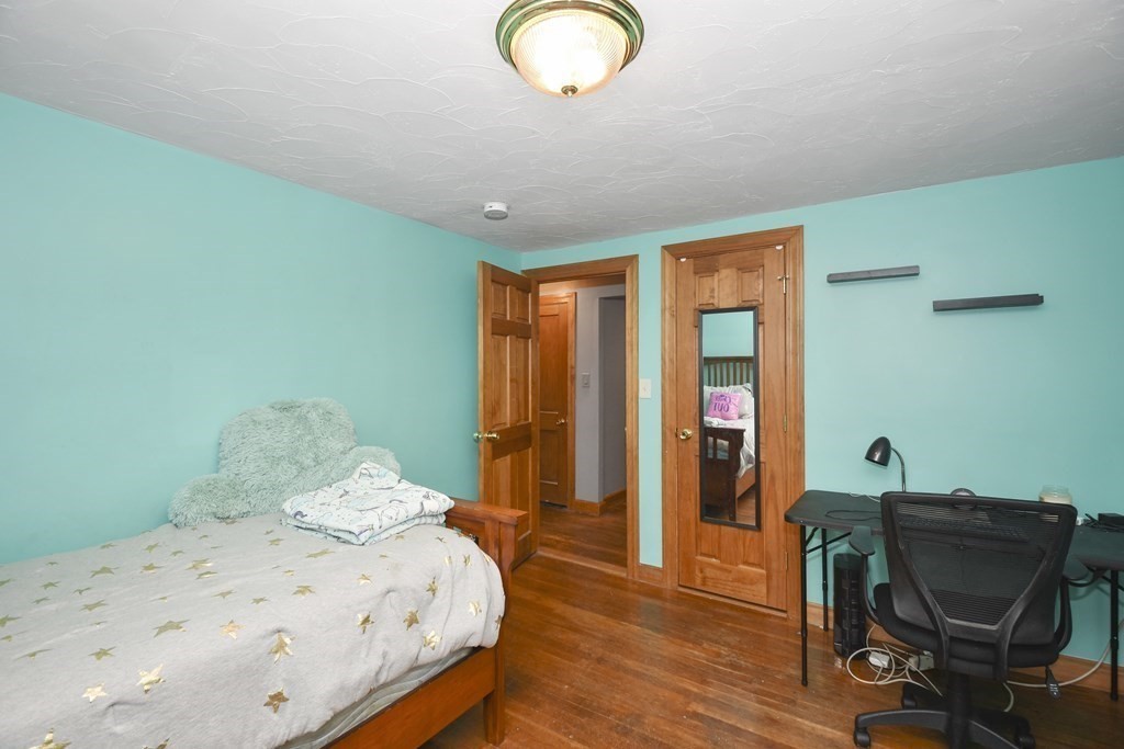 22 Carleton Road Leicester, MA 01542 - Photo 17 of 28 a bedroom with a bed and a chair