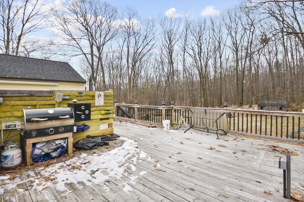22 Carleton Road Leicester, MA 01542 - Photo 26 of 28 a view of a roof deck with wooden fence and trees