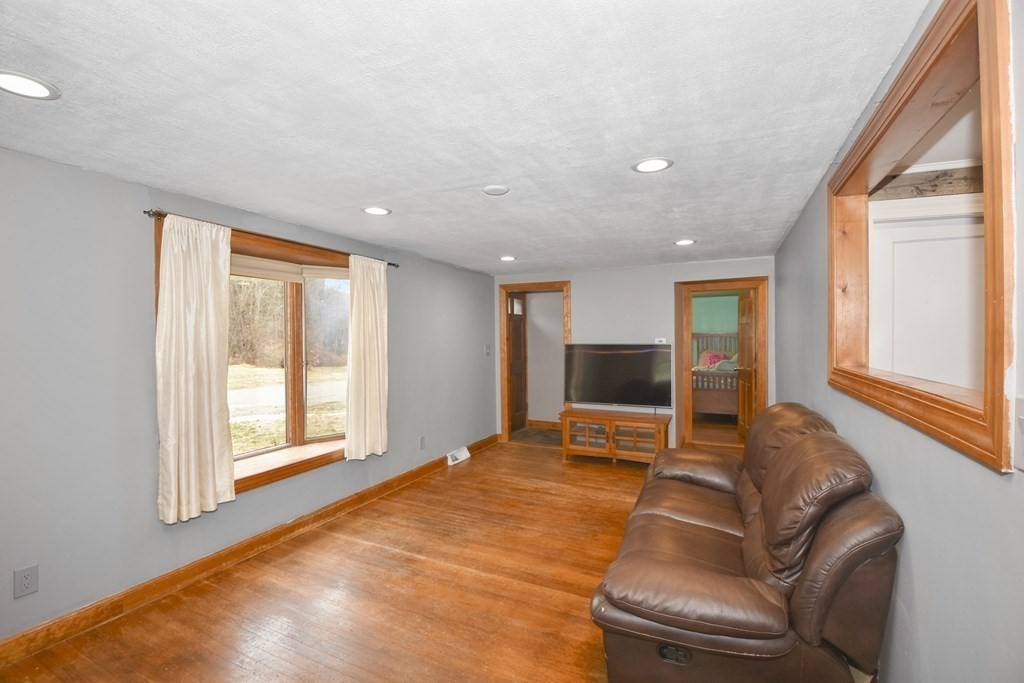 22 Carleton Road Leicester, MA 01542 - Photo 3 of 28 a living room with a balcony furniture and a large window