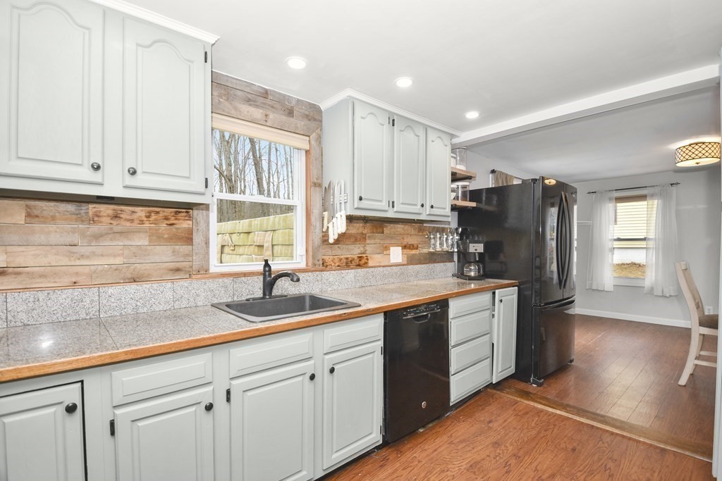 22 Carleton Road Leicester, MA 01542 - Photo 8 of 28 a kitchen with kitchen island granite countertop a sink stainless steel appliances and cabinets