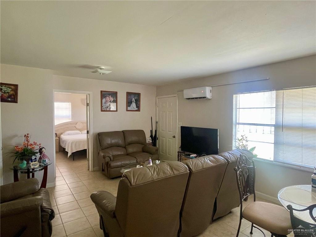 3107 North Hutto Road Donna, TX 78537 - Photo 2 of 11 a living room with furniture a flat screen tv and a window
