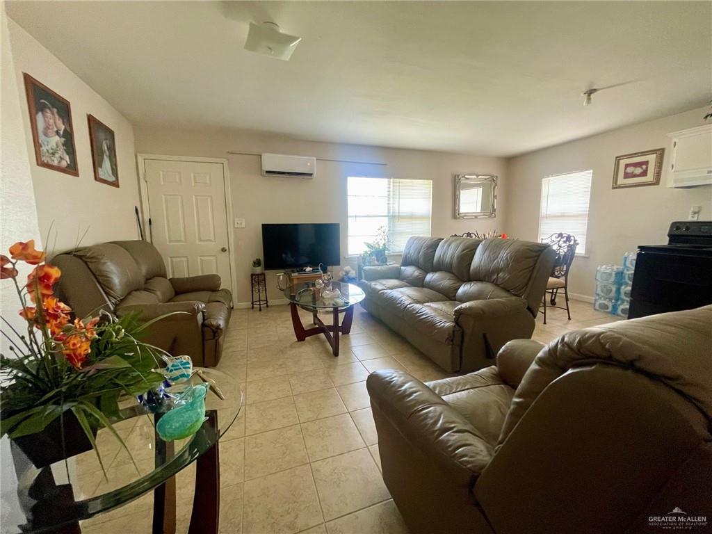 3107 North Hutto Road Donna, TX 78537 - Photo 3 of 11 a living room with furniture and a flat screen tv
