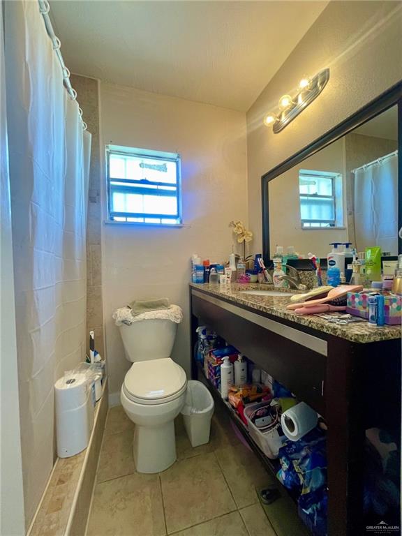 3107 North Hutto Road Donna, TX 78537 - Photo 6 of 11 a bathroom with a sink a toilet and a mirror