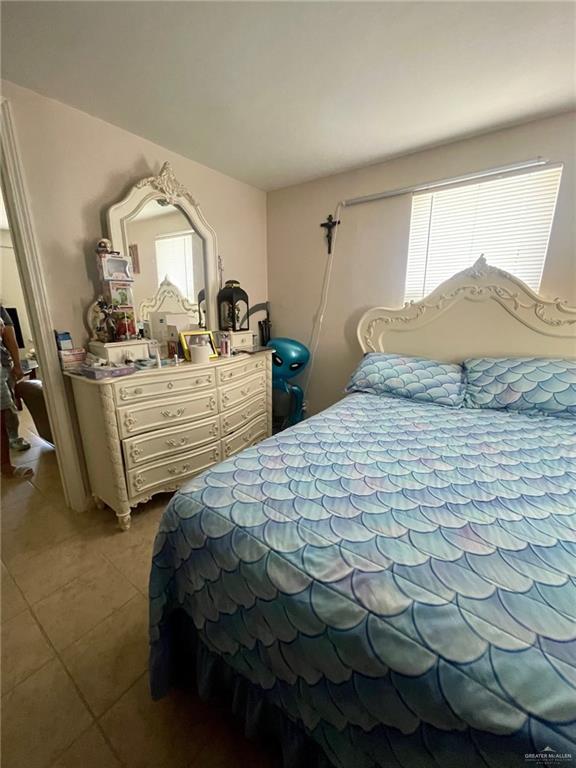 3107 North Hutto Road Donna, TX 78537 - Photo 9 of 11 a bedroom with a bed mirror and window