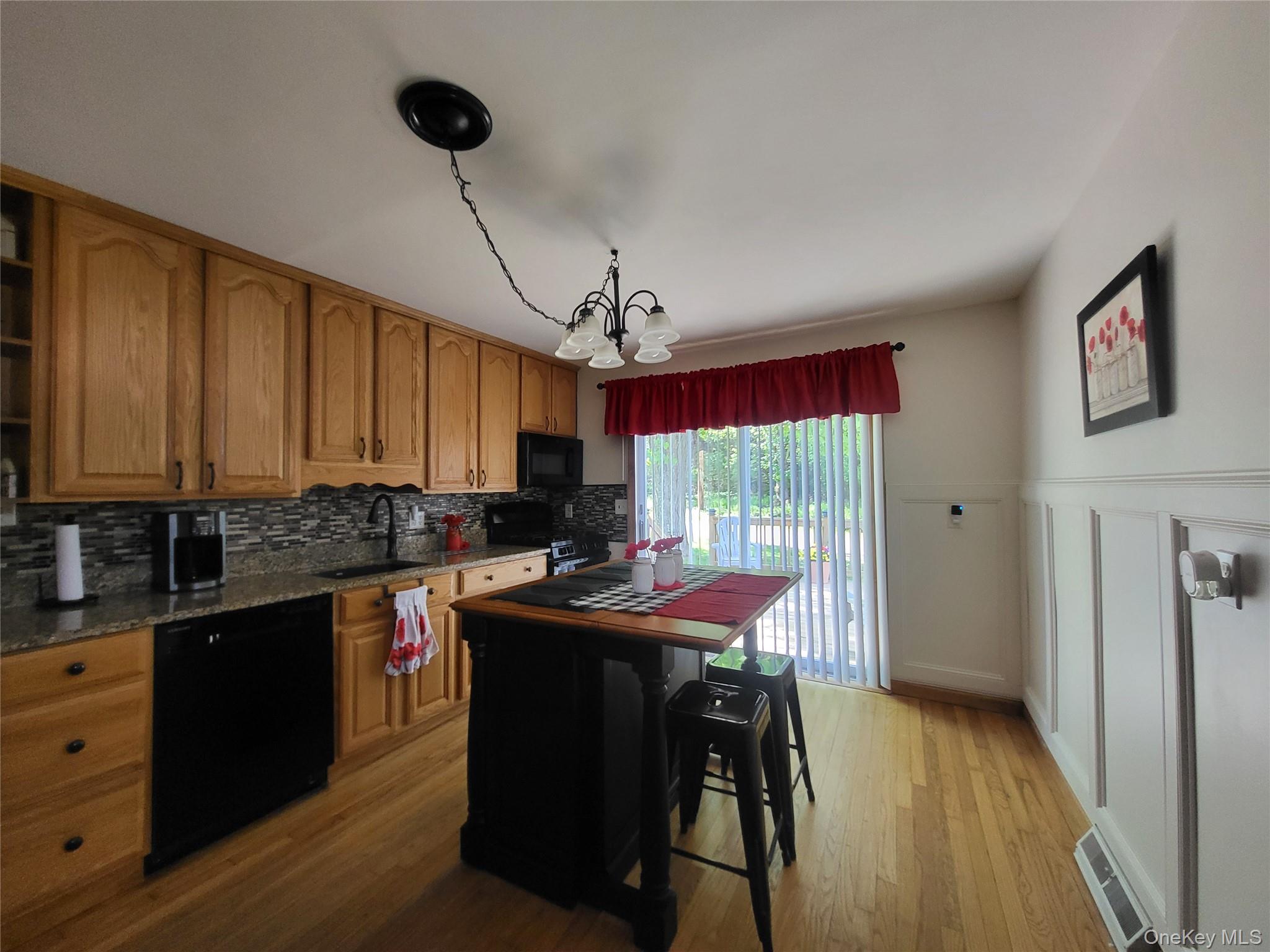 286 Dingle Daisy Road Monticello, NY 12701 - Photo 11 of 35 a kitchen that has a sink a table and chairs in it