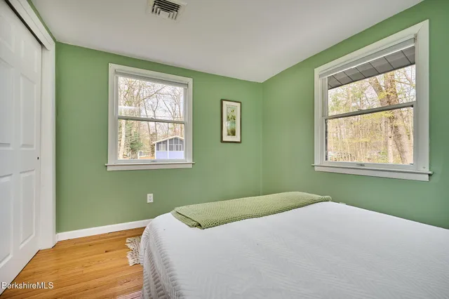 a bedroom with a bed and windows