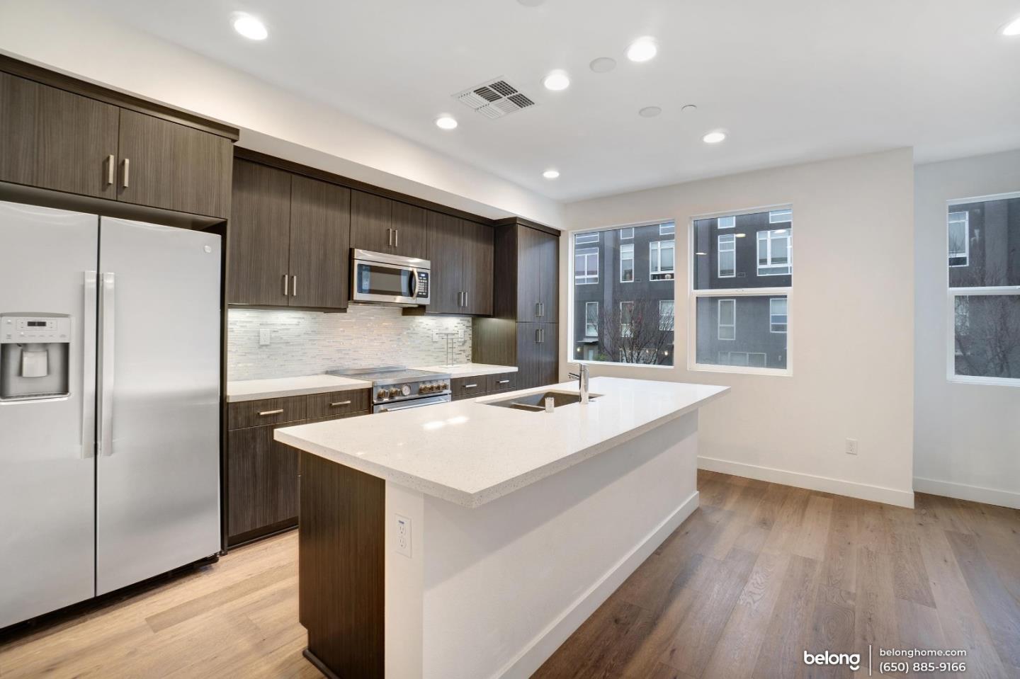 1351 Pullman Way Oakland, CA 94607 - Photo 16 of 24 a kitchen with a stove a refrigerator and a sink