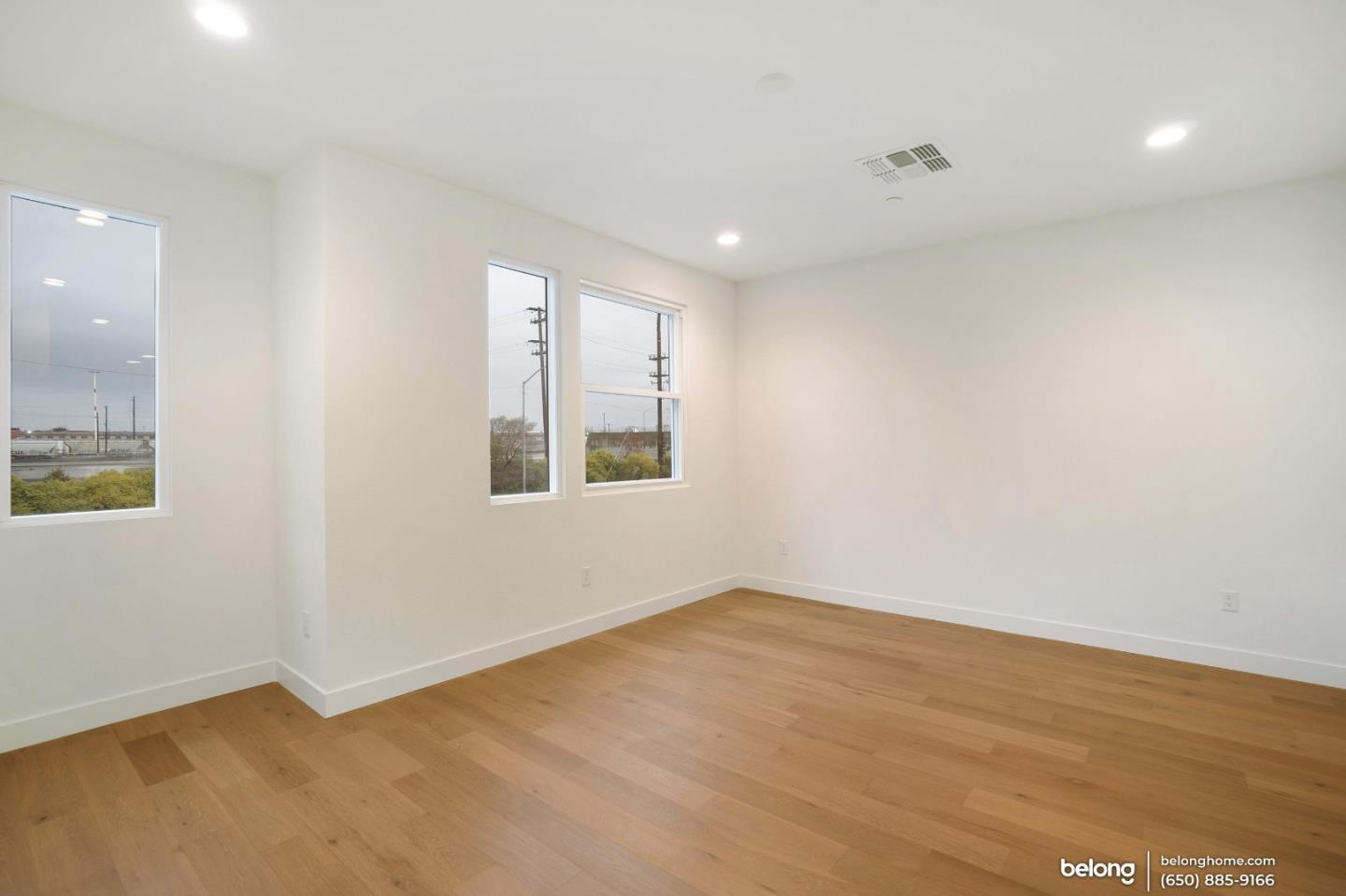 1351 Pullman Way Oakland, CA 94607 - Photo 5 of 24 an empty room with wooden floor and windows