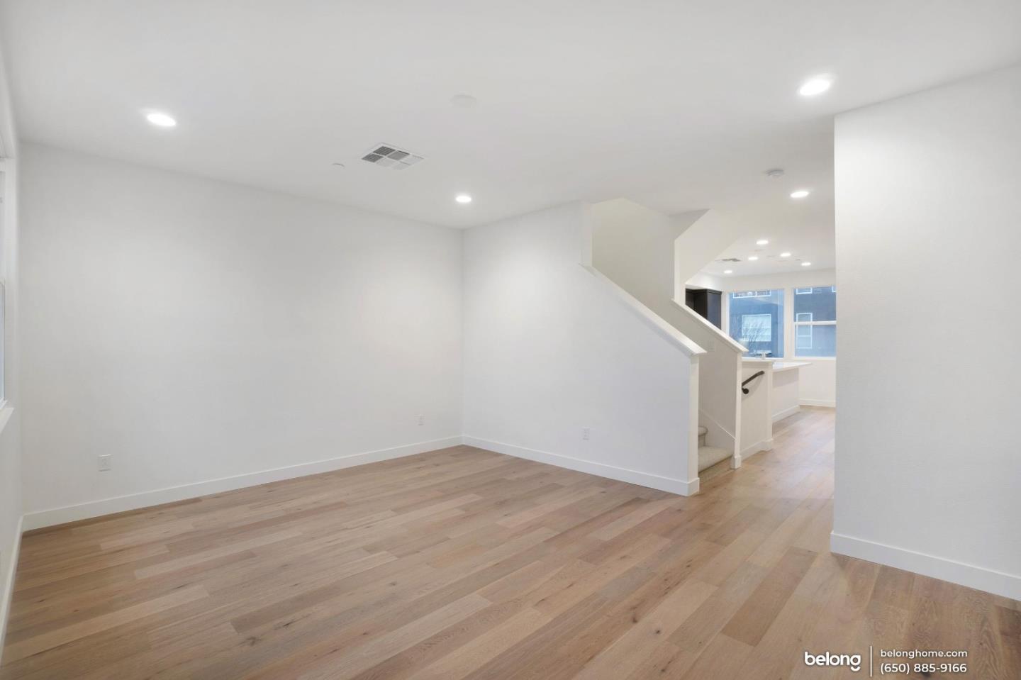1351 Pullman Way Oakland, CA 94607 - Photo 6 of 24 an empty room with wooden floor and white walls