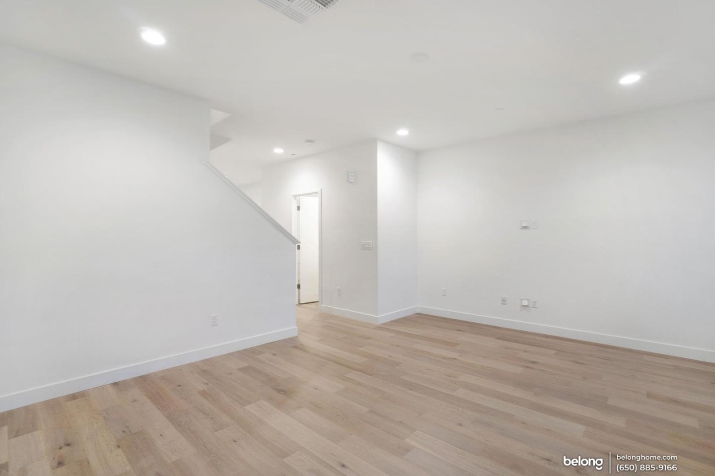 1351 Pullman Way Oakland, CA 94607 - Photo 8 of 24 an empty room with wooden floor and white walls