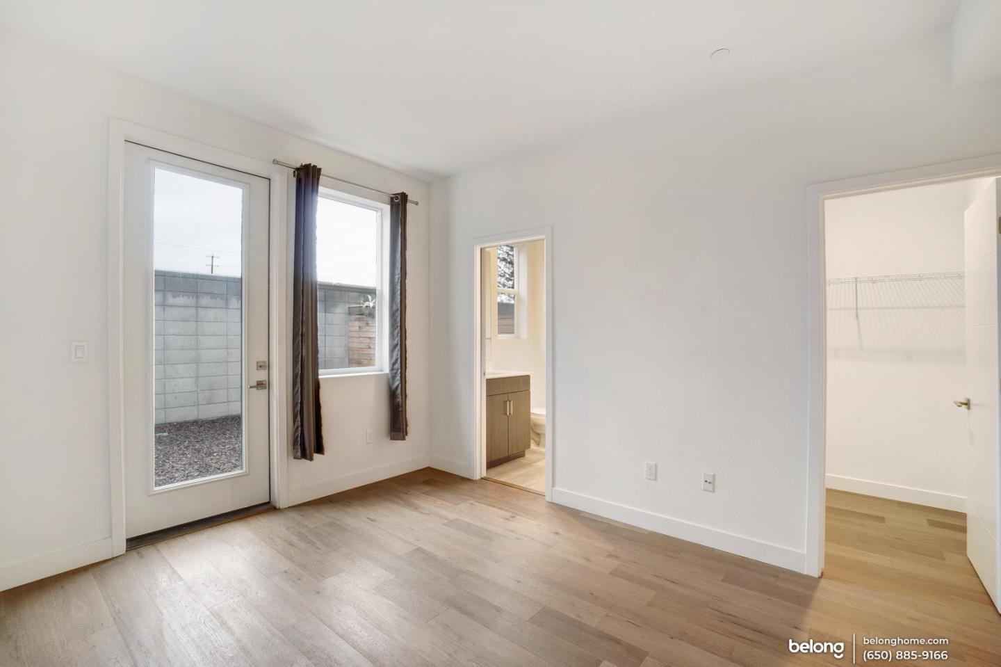1351 Pullman Way Oakland, CA 94607 - Photo 9 of 24 an empty room with wooden floor and windows