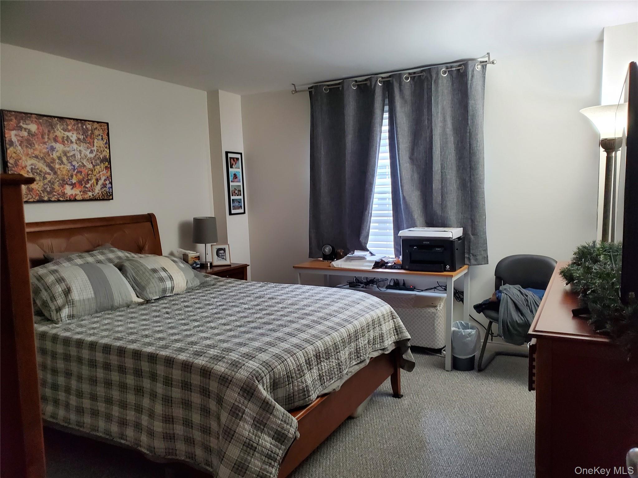 360 Shore Road, Unit 5A Long Beach, NY 11561 - Photo 7 of 16 a bedroom with a bed and a dresser next to a window