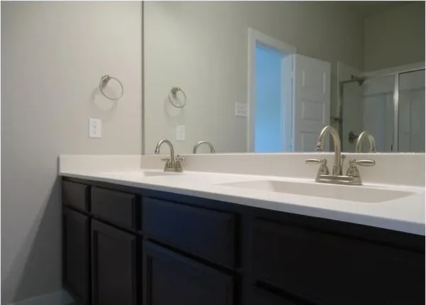 a bathroom with double sink and a mirror