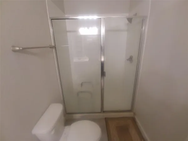 a bathroom with a shower and toilet