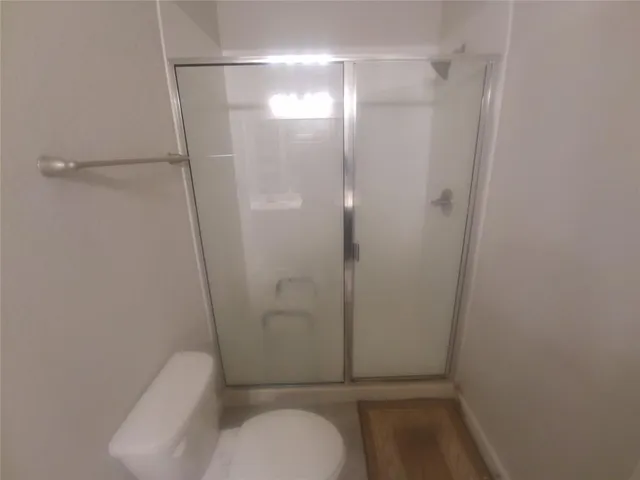 a bathroom with a shower and toilet