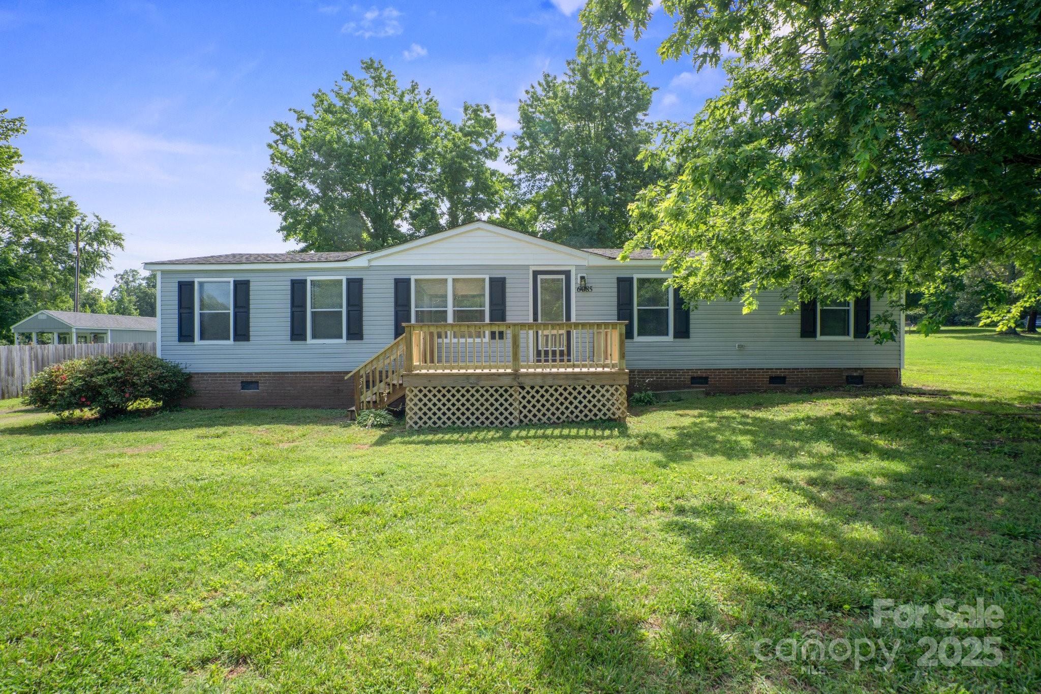 6085 Faith Road Salisbury, NC 28146 - Photo 1 of 29 a view of a house with a yard and a garden
