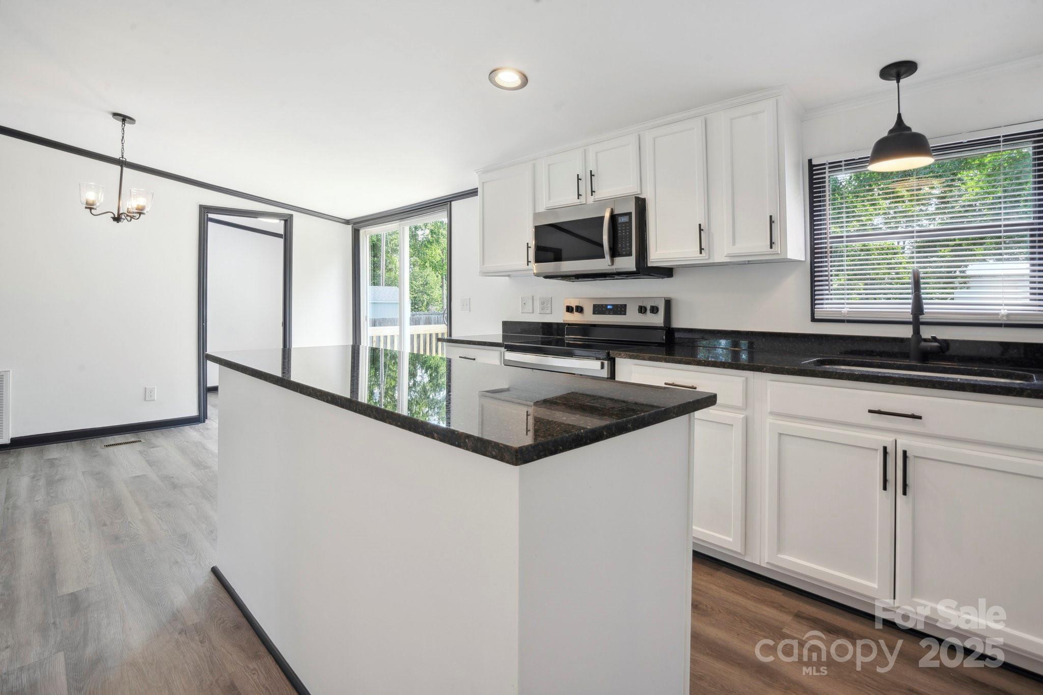 6085 Faith Road Salisbury, NC 28146 - Photo 19 of 29 a kitchen that has a sink and a stove in it