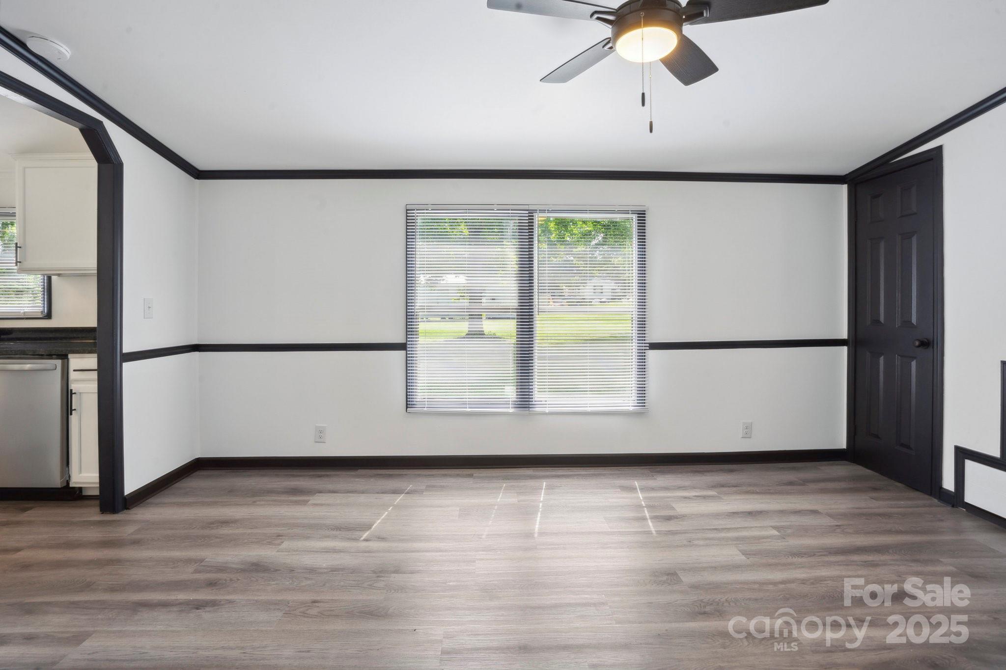 6085 Faith Road Salisbury, NC 28146 - Photo 4 of 29 a view of a big room with wooden floor and windows