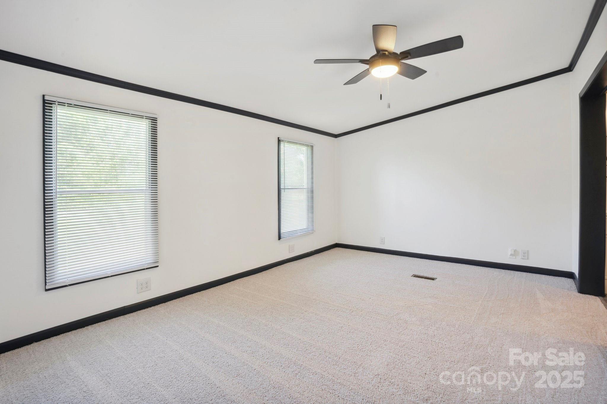 6085 Faith Road Salisbury, NC 28146 - Photo 8 of 29 an empty room with windows and fan