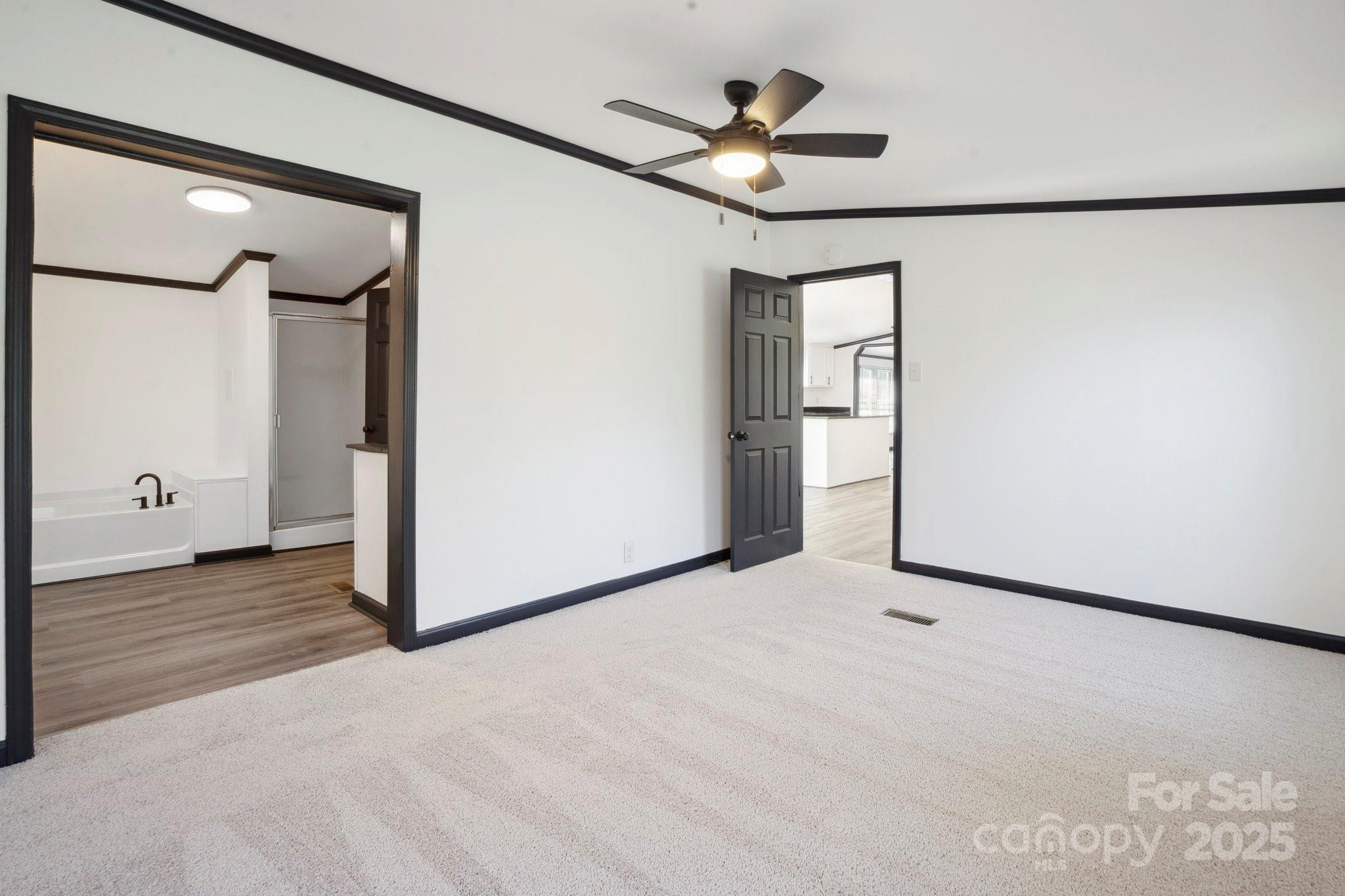 6085 Faith Road Salisbury, NC 28146 - Photo 9 of 29 a view of a livingroom with a ceiling fan and wooden floor