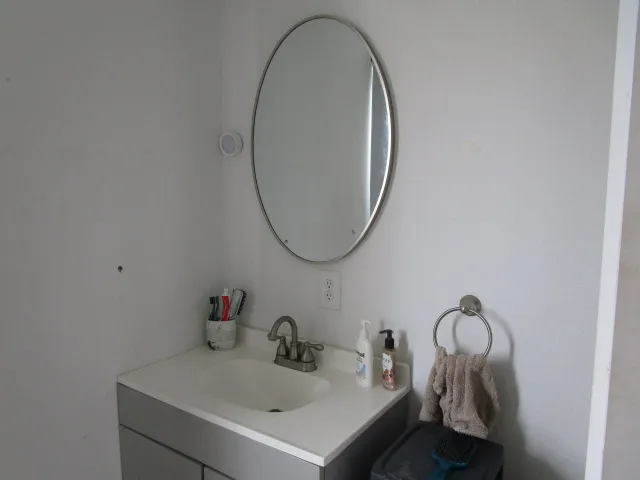 a bathroom with a sink and mirror