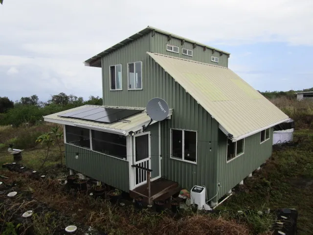 a aerial view of a house with a yard and balcony