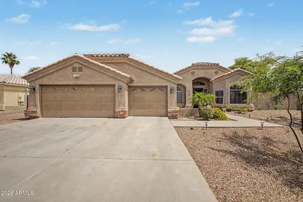 a front view of a house with a yard and garage