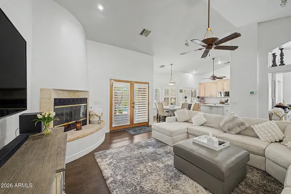 a living room with furniture a flat screen tv and a fireplace