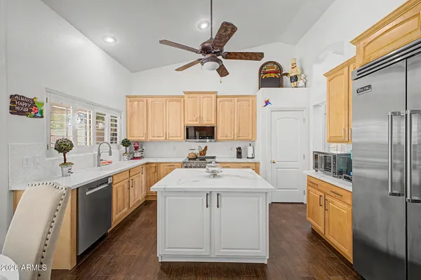 a kitchen with a sink appliances and cabinets