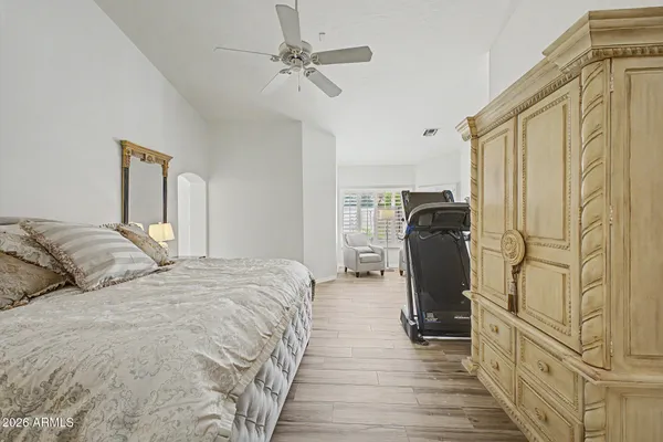 a bedroom with bed and wooden floor