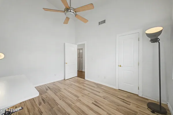 a view of a room with wooden floor and fan
