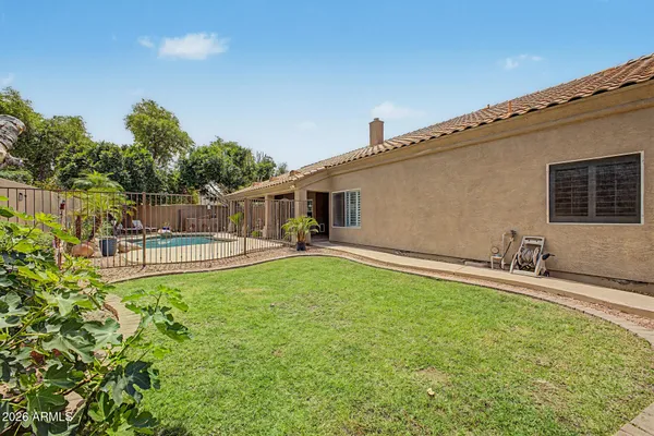 a view of a house with backyard and sitting area