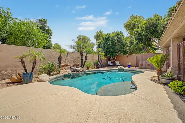 a view of a house with backyard and sitting area