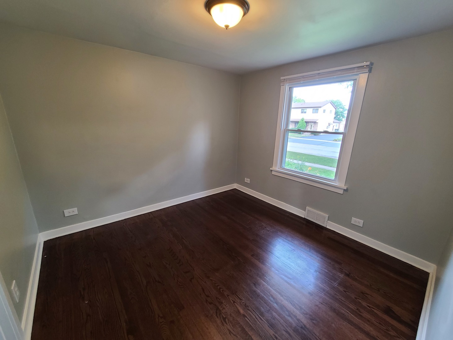 11032 Major Avenue Chicago Ridge, IL 60415 - Photo 5 of 10 an empty room with wooden floor and windows