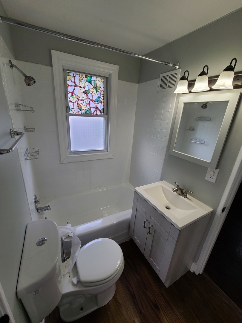 11032 Major Avenue Chicago Ridge, IL 60415 - Photo 6 of 10 a bathroom with a toilet sink and mirror